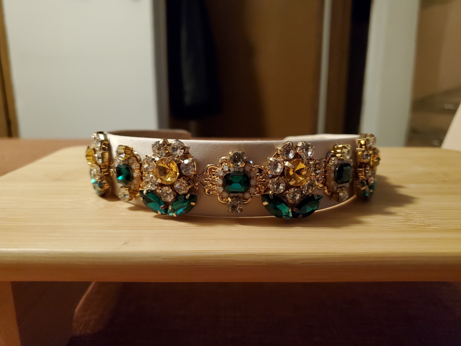 White Beaded Headband with Gold and Green Rhinestone Accents
