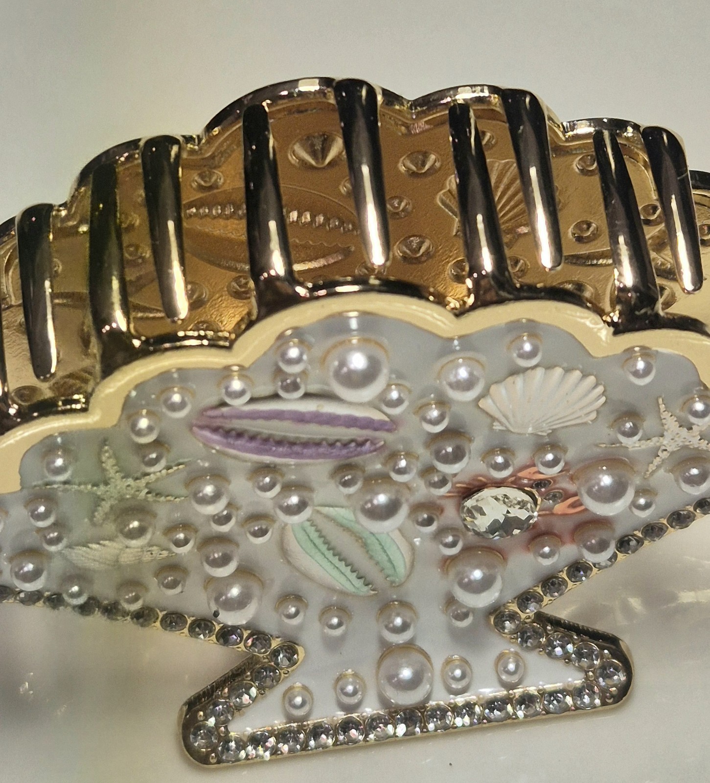 Gold seashell hair clip with rhinestones & pearls, beach-style metal clip.