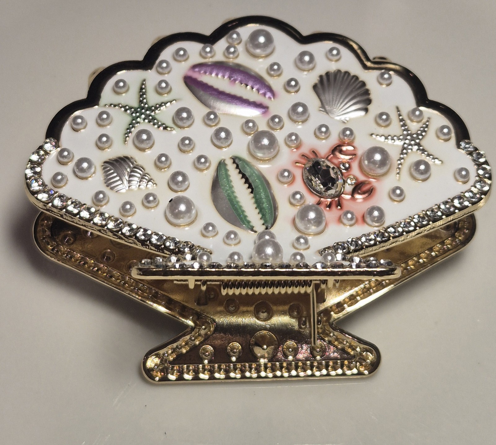 Gold seashell hair clip with rhinestones & pearls, beach-style metal clip.