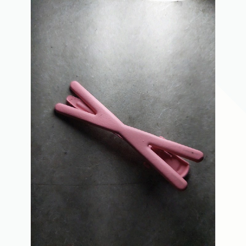 Pink hair clip with an X shape