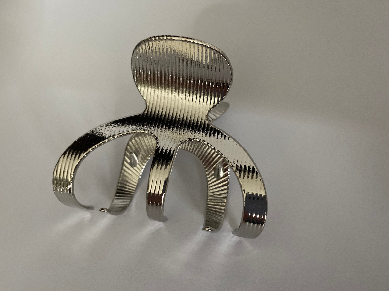 Medium shiny silver tone textured metal hair claw clip